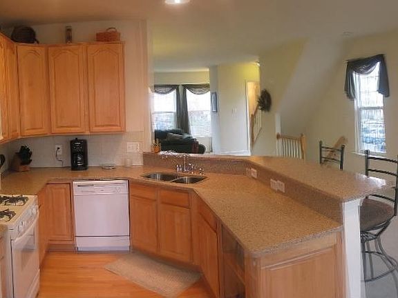Remodeled kitchen with granite counters and maple cabinets.