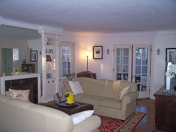 Spacius Living Room with French doors leading to enclosed porch.