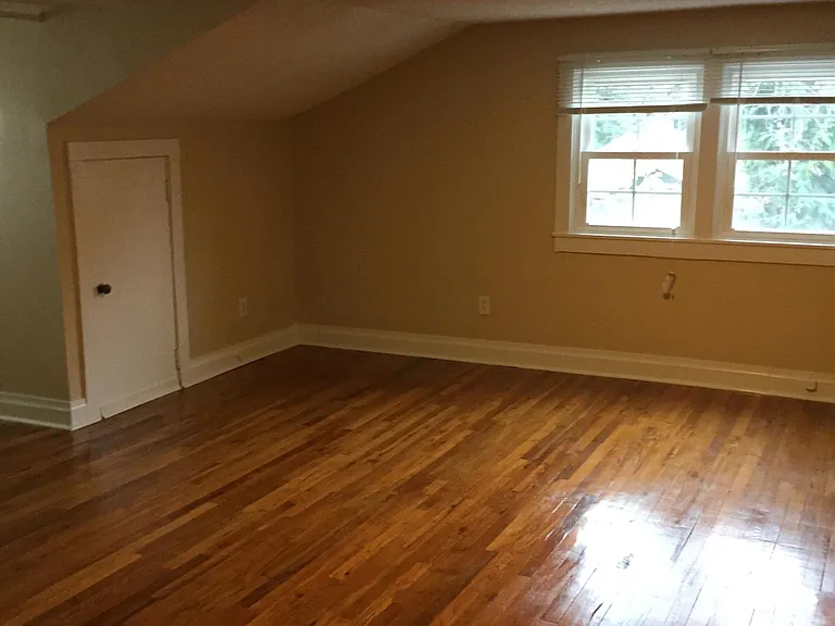 bedroom with overlooking parking pad and attic closet