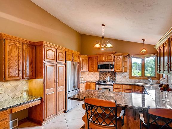 Additional kitchen features include the built-in desk and snack bar seating.