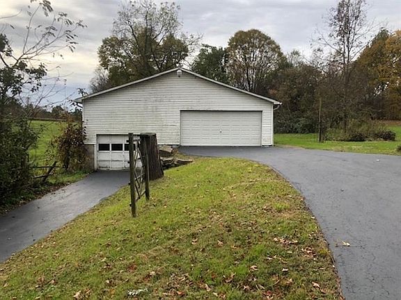ENTER THE GARAGE FROM THIS SIDE FOR CARS OR FROM SIDE WITH FARM EQUIP THOUGH 12 FOOT DOORS. 2 LARGE OFFICES ARE ALSO IN THIS GAR