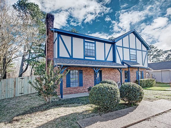 Charming Tudor-style exterior with classic architectural details and private parking.