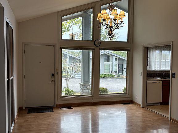 Vaulted ceiling in the Great room, gleaming floors, light streaming inside from large window