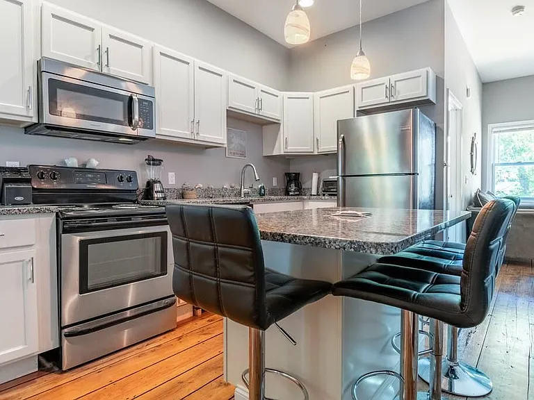 Kitchen Stainless Steel Appliances Modern Kitchen Granite Countertops Bar Seating Eat-in Kitchen Hardwood Floors Open Concept