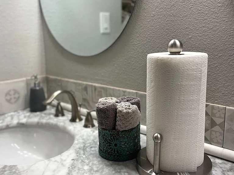 Dual sink vanity with marble countertops and sink vanity storage