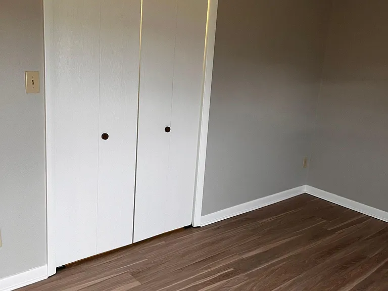 large lighted closet with shelves in the primary bedroom