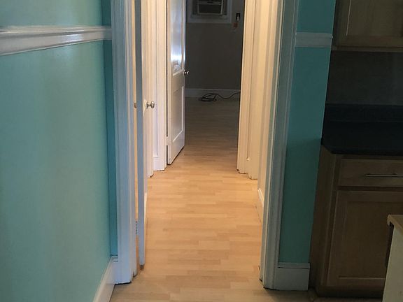 Walkway from kitchen to bathroom, large closet, and bedroom