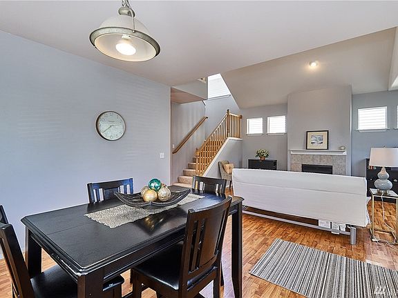 The freshly painted living room is light and airy with vaulted ceilings, recessed lighting and a gas fireplace to enjoy- look at all the windows!