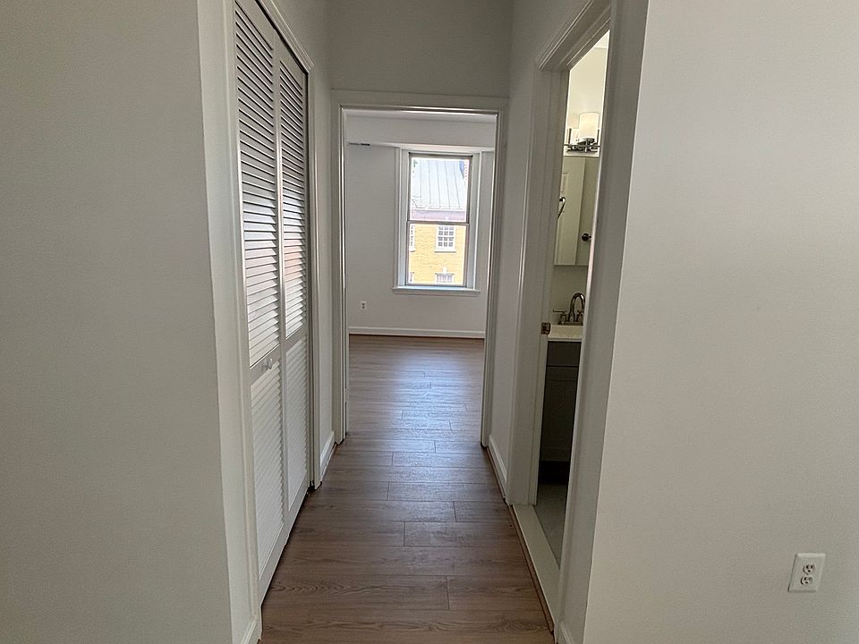 Hallway from the living/dining room to the bedroom. New hardwood floors throughout the apartment.