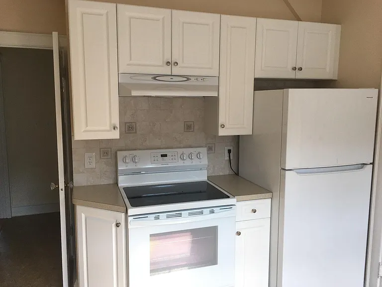 kitchen showing stove and refrigerator
