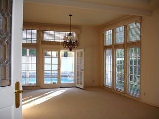 floor to ceiling windows in living room and dining room, french doors to pool 