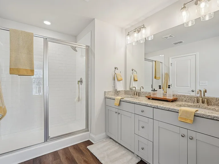 Primary bathroom with double vanity, and walk-in shower.