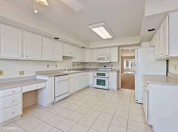 Abundant cabinetry and counter space, including a pantry cabinet and desk area!