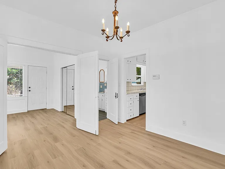 Dining room, and a view of the 2nd downstairs bedroom, bathroom, and kitchen.
