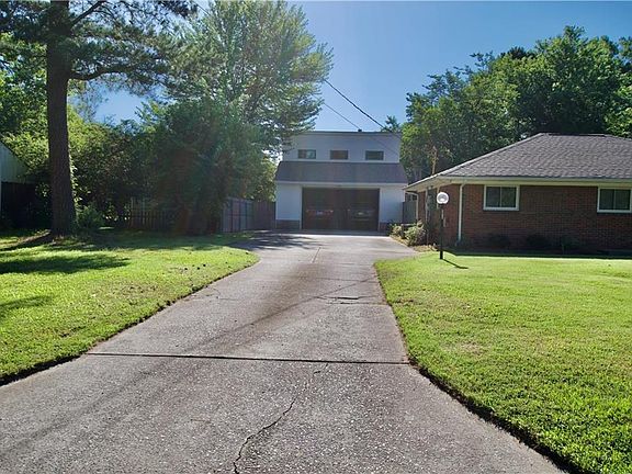 Long driveway leading to an incredible 2 story double car garage!
