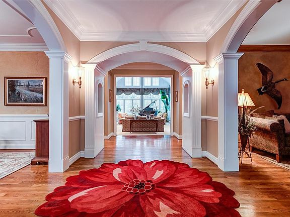 Formal entrance hall to greet guests with arched doorways and custom moldings and woodwork