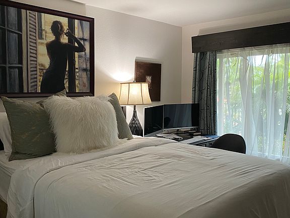 Queen bed with a desk and book case and a chair