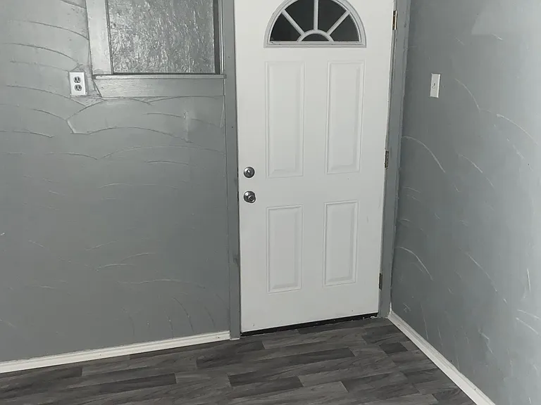 Soor to third bedroom that is accessed from outside covered parking area.