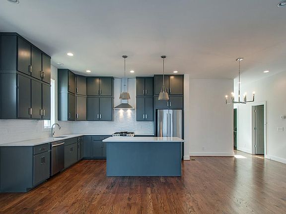 Fabulous oversized kitchen is a focal point in the downstairs open living space. (not pictured is half bath on first level)