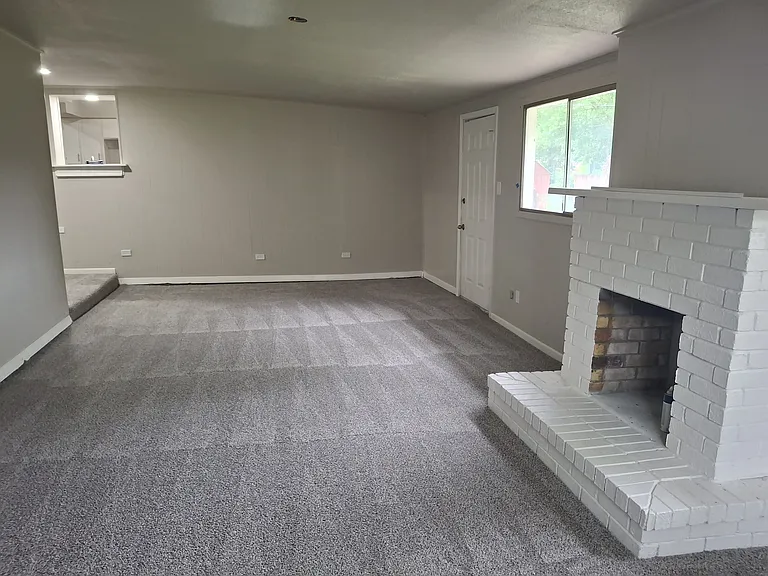 Family room facing towards kitchen. Fireplace will have electric insert.