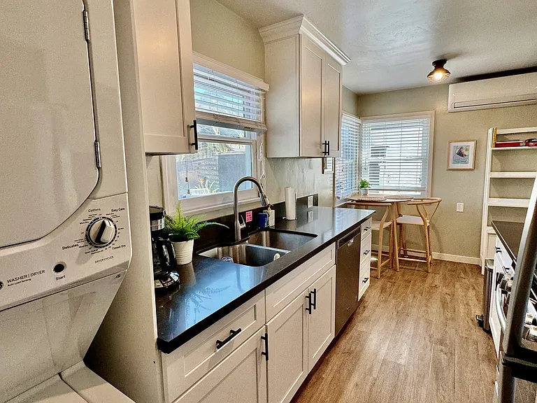 Full kitchen with gas stove and oven, washer/dryer, dishwasher, dining table for two, and everything else you would need