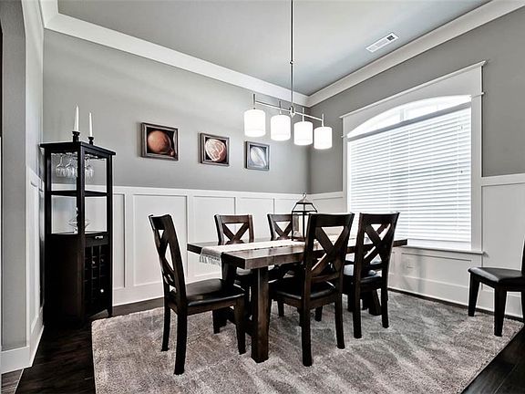 Formal Dining Room Features Beautiful Accents Including Clean-lined, Modern Wainscotting & Delicate Lighting Making Your Guests Feel Cozy, Relaxed and in the Lap of Luxury at the same time!