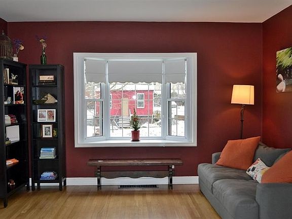 LIVING ROOM.  Here is one of the matching bay windows, at the front of the house.  Note the lovely contemporary color in this sp