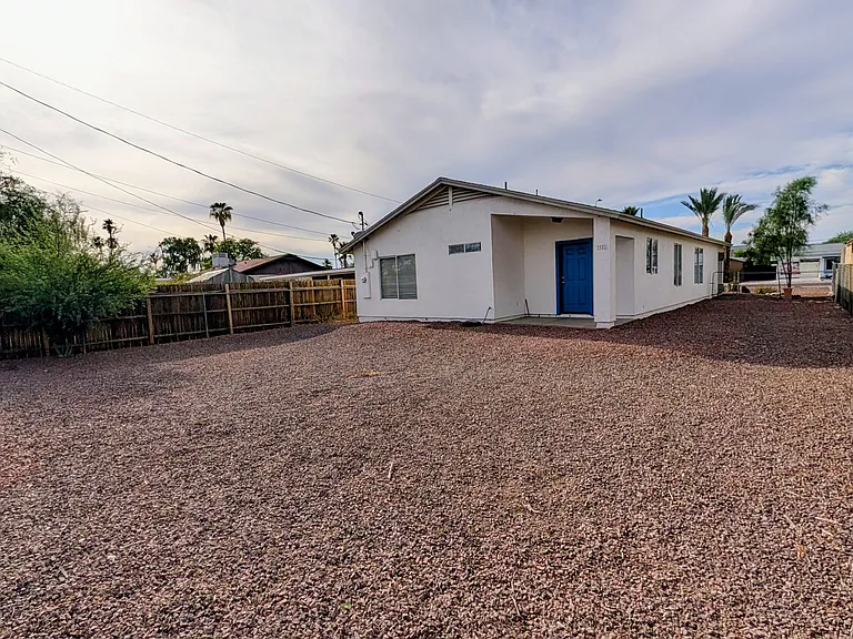 Enjoy a clean, functional outdoor space featuring rock landscaping and a full fence. Backyard includes a rear gate for convenient access to the shared alley bins for garbage pickup. Designed for minimal upkeep.