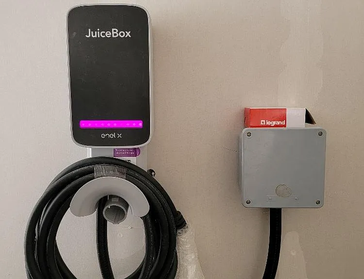 Electric vehicle charging stations in select garages