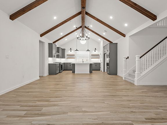 Great room featuring vaulted ceiling stained ceiling beams