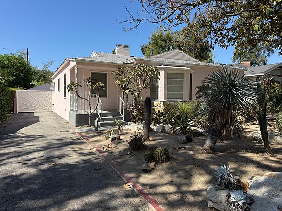 Long driveway with electric gate leads to 2 car garage
