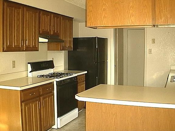 Eat-in kitchen with bay window and refrigerator will remain.