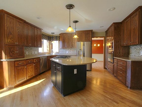 Gourmet kitchen w/ beautiful Craftsman cabinetry. Oversized kitchen island. Cambria countertops and modern light fixtures.