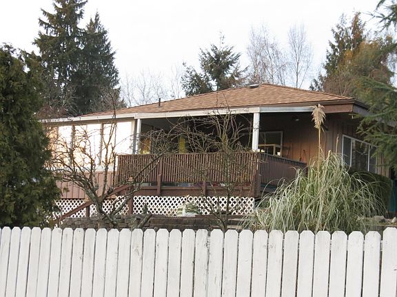 Winter view of the house (of the upper floor) from the street (the trees fill out in the summer)