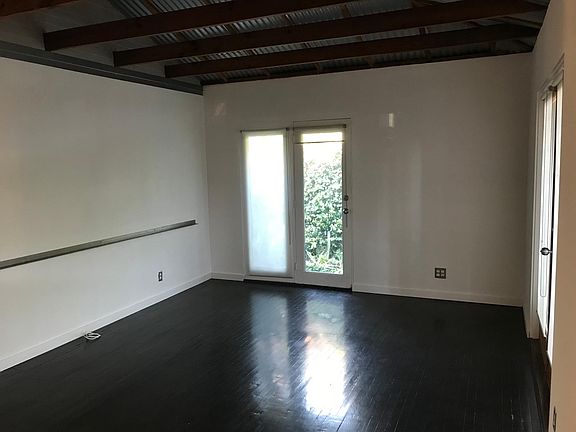 Main Living room w vaulted ceiling clad in corrugated metal panels