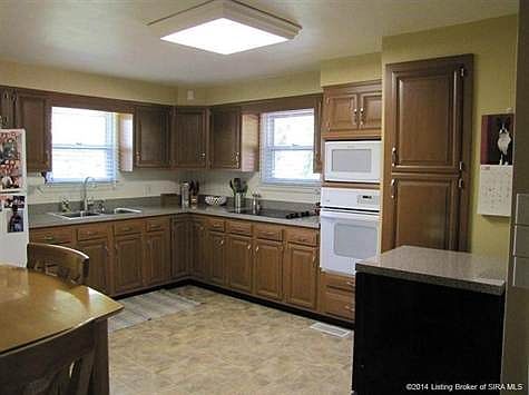 Kitchen has been updated with new countertops, faucets and flooring.