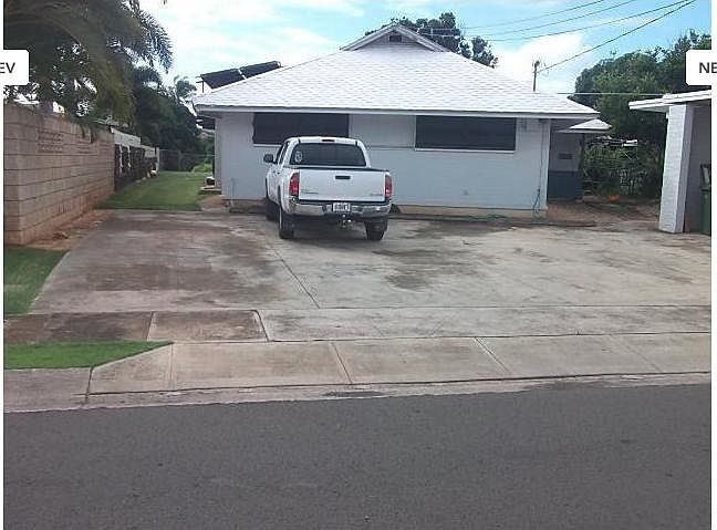 FRONT VIEW w/CARPORT ON RIGHT OFF STREET PARKING FOR 5 VEHICLES w/2 in CARPORT