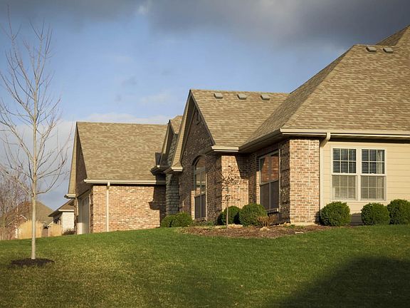 Brick quoins wrap to concrete siding.