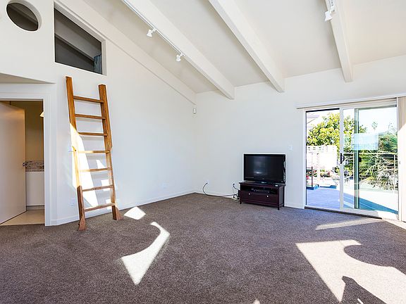 Living area with deck access for amazing ocean views and loft space