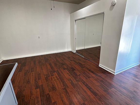living space & front storage/closet with large mirror paneling