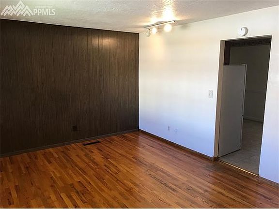 View of living room from front entrance. Natural wood floors!