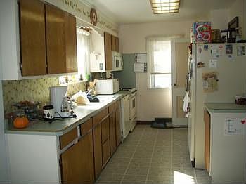 Kitchen with range, refrigerator, dishwasher and disposal.