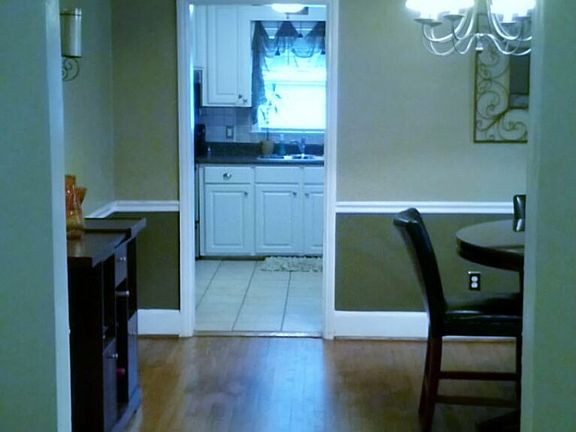 Dining Room: Arched entryway, hardwood floors, updated lighting fixtures  