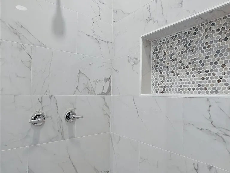 Full bath with a tile shower