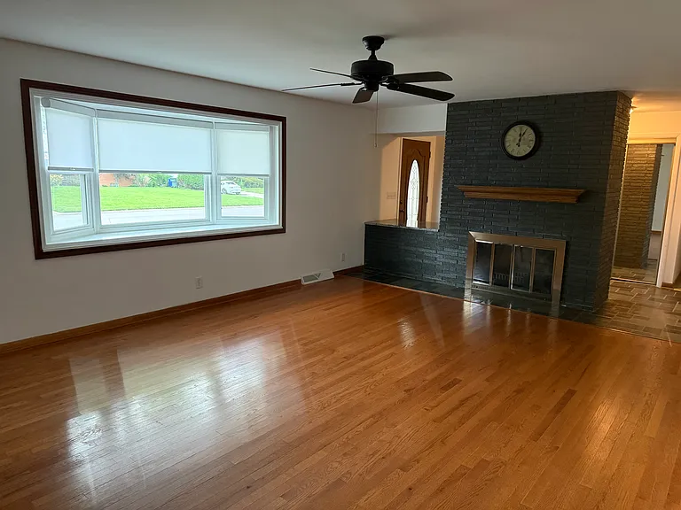 Living room with large picture window and fireplace.