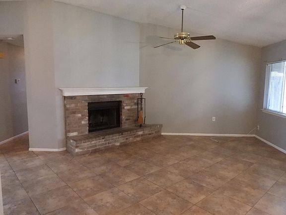 Family room, ceiling fan, and a window onto the back yard, and a fireplace