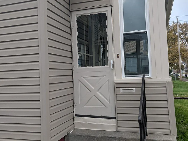 Super cute enclosed front porch with fan, new windows.