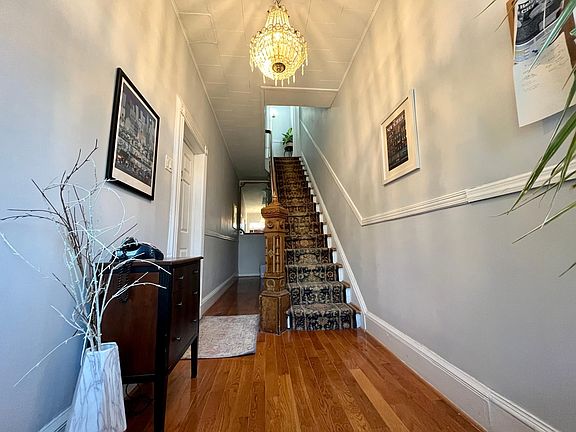 Hallway leading to apartment and downstairs for laundry room
