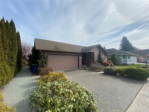 Ample parking and walkway along side of home, two car garage.
