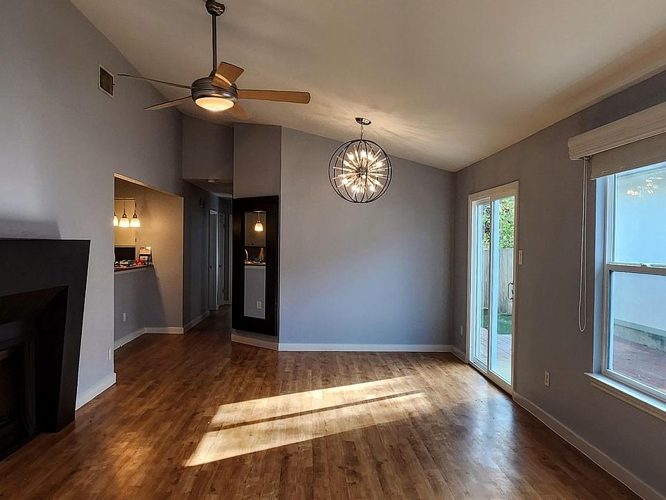 Living and dining room with fireplace; glass doors to private patio.
Bathroom 2 at the end of the hallway. Master bedroom and linen closet to the left; 2 bedrooms on the right.